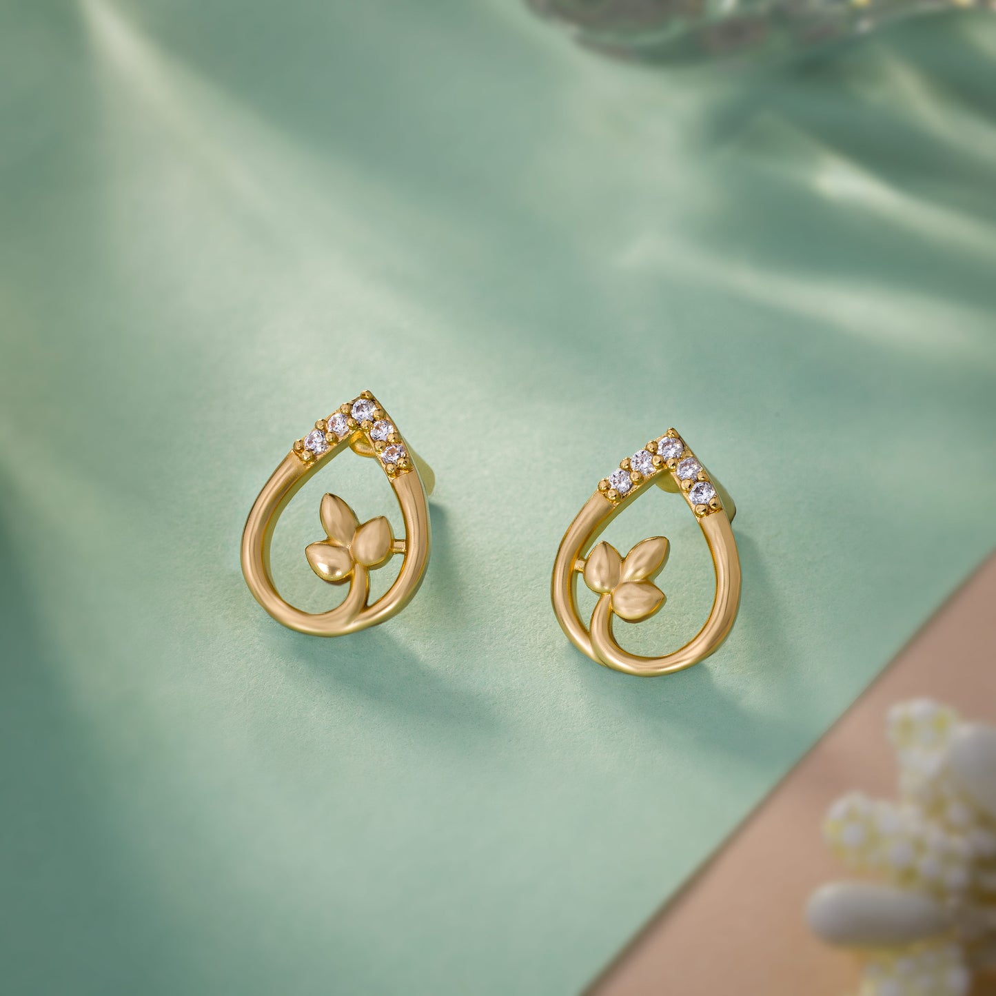 pair of golden earrings with diamonds