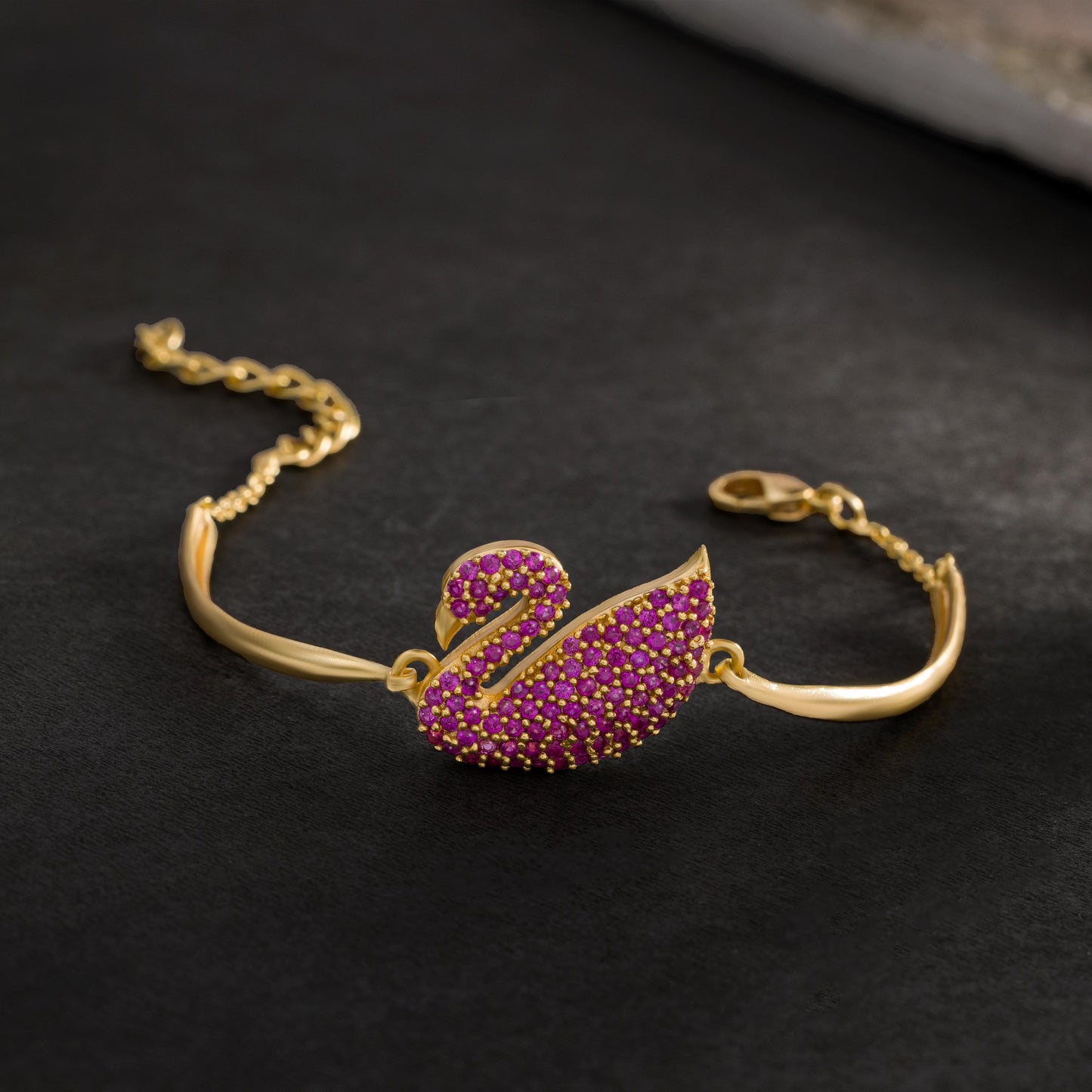 golden bracelet with a swan on it