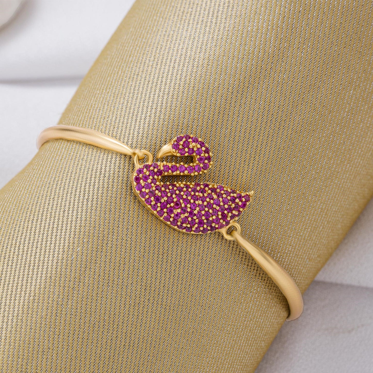 golden bracelet with a swan on it