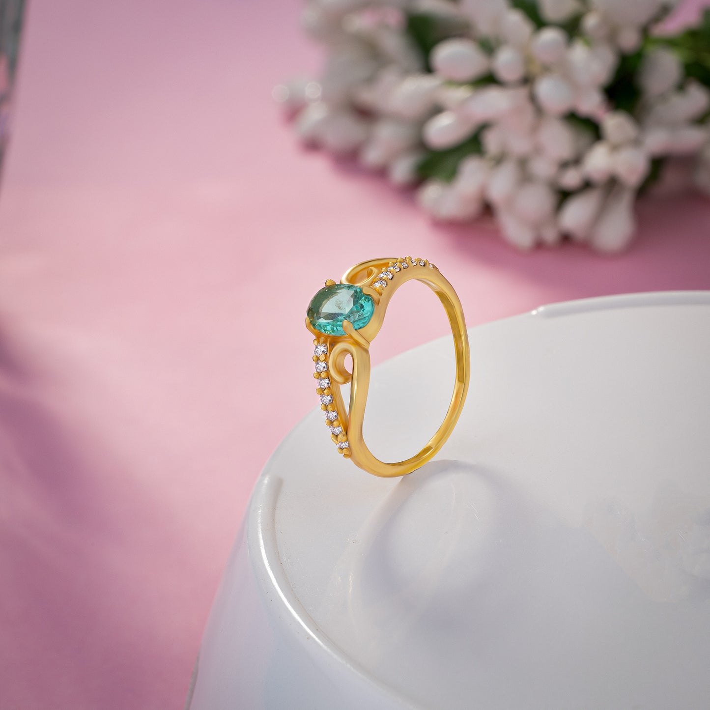 golden ring with a tourmal stone and diamonds