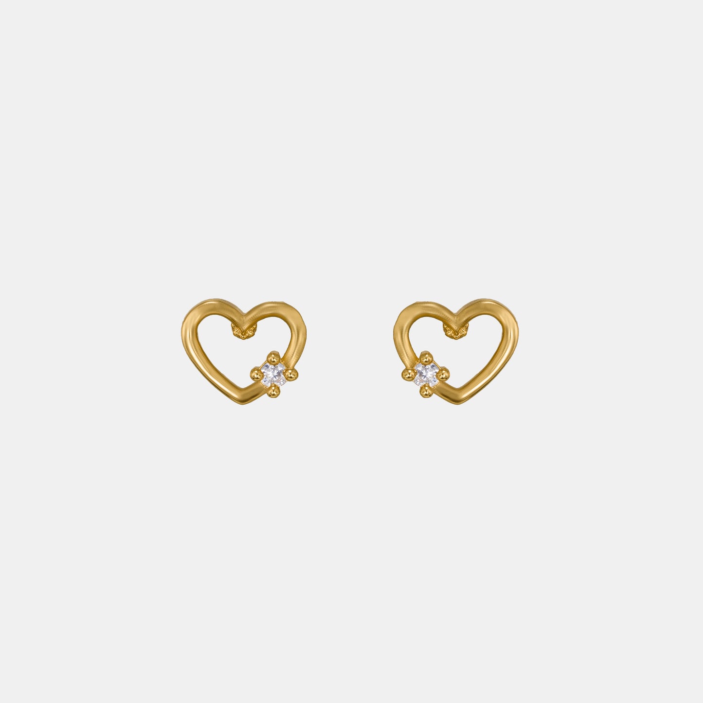 pair of golden earrings with a heart shaped diamond