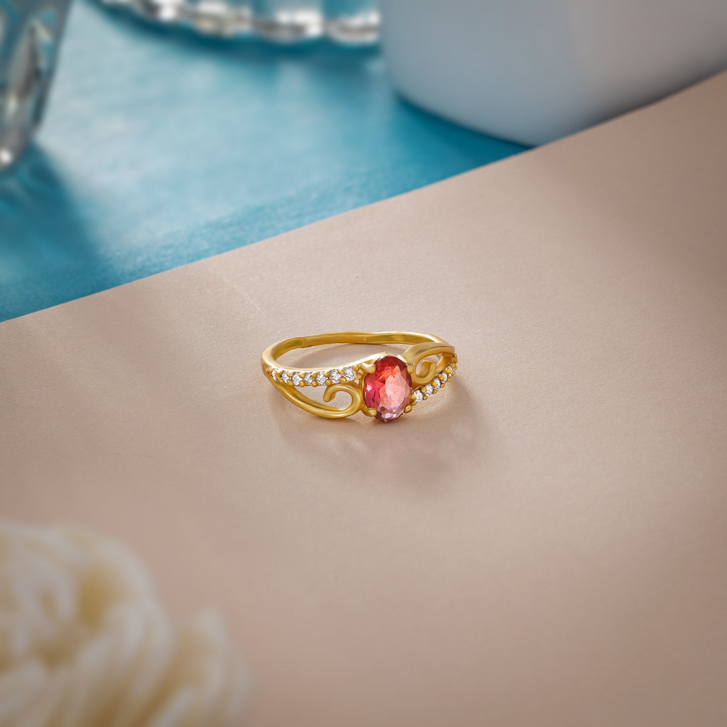 golden ring with a tourmal stone and diamonds