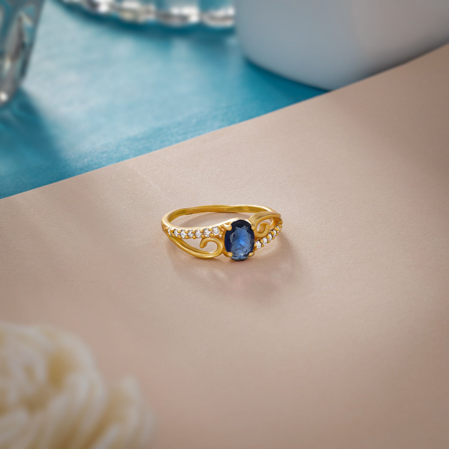 golden ring with a tourmal stone and diamonds