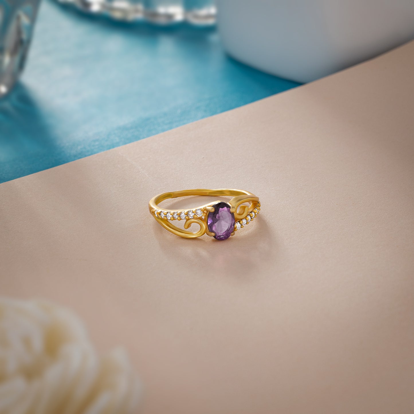 golden ring with a tourmal stone and diamonds