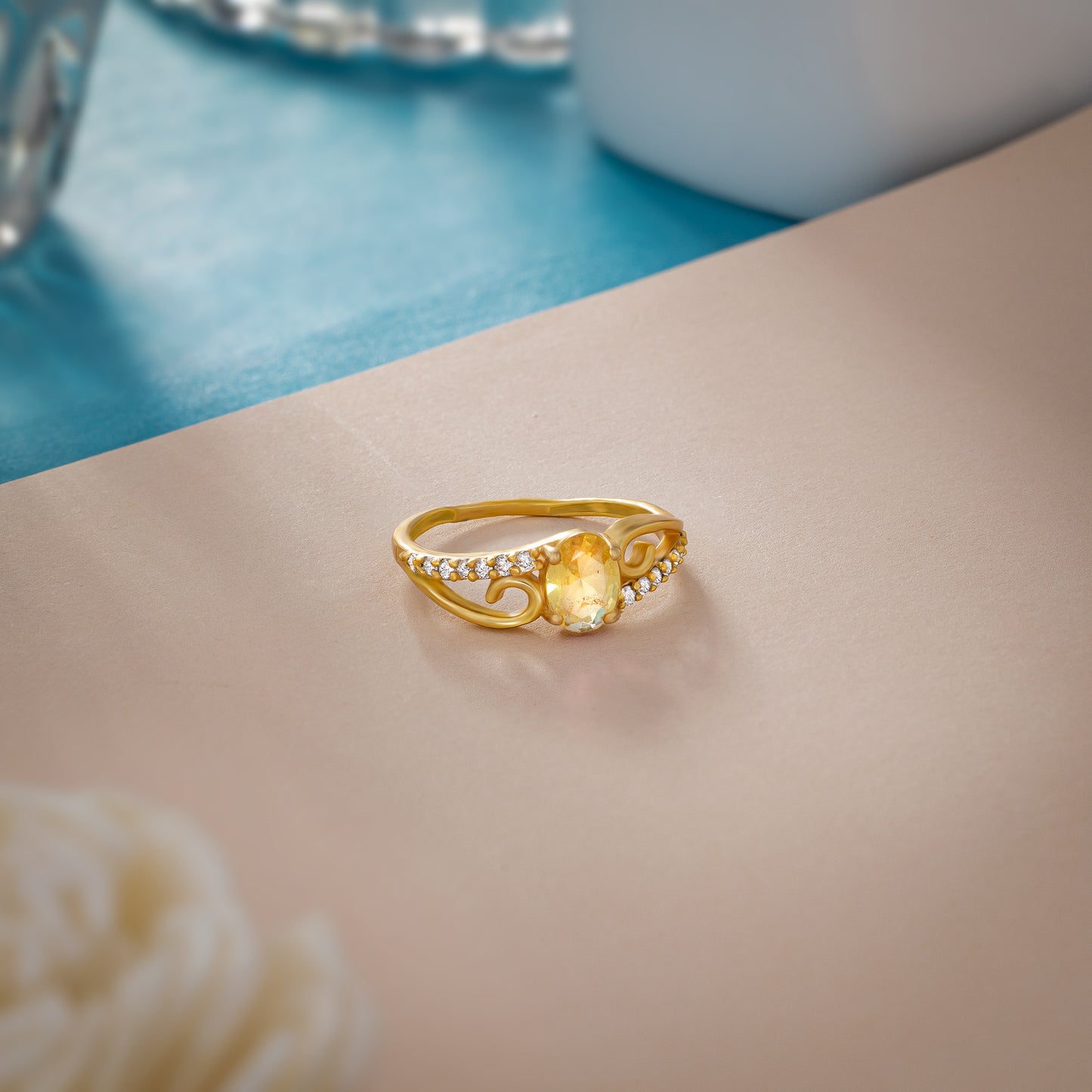 golden ring with a tourmal stone and diamonds