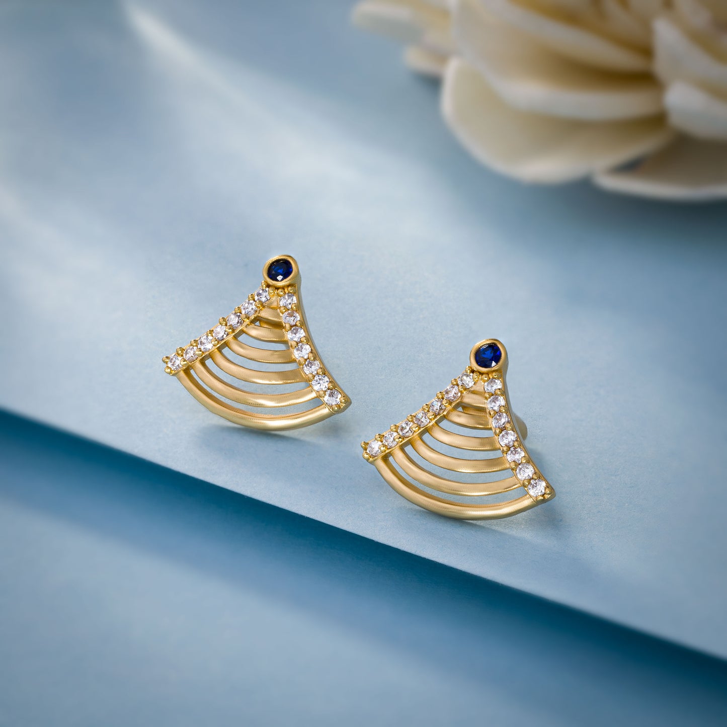 pair of golden earrings with sapphire and diamonds