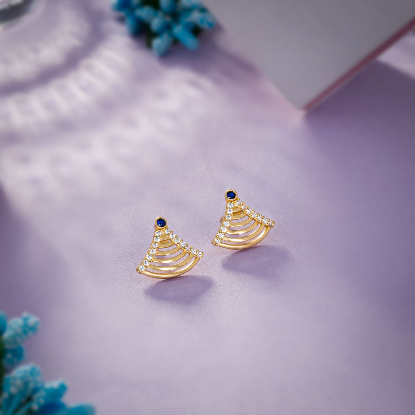 pair of golden earrings with sapphire and diamonds