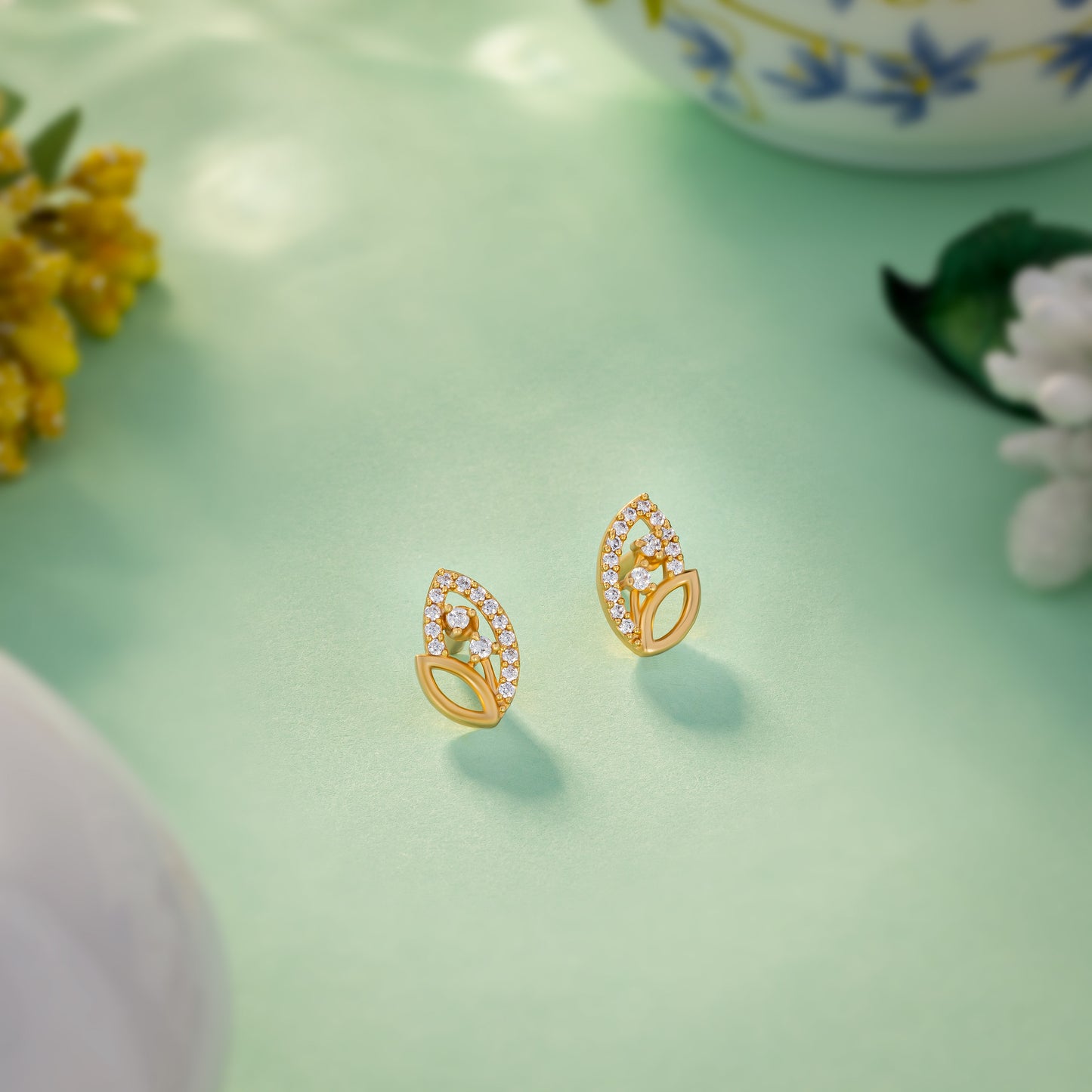 pair of golden earrings with diamonds