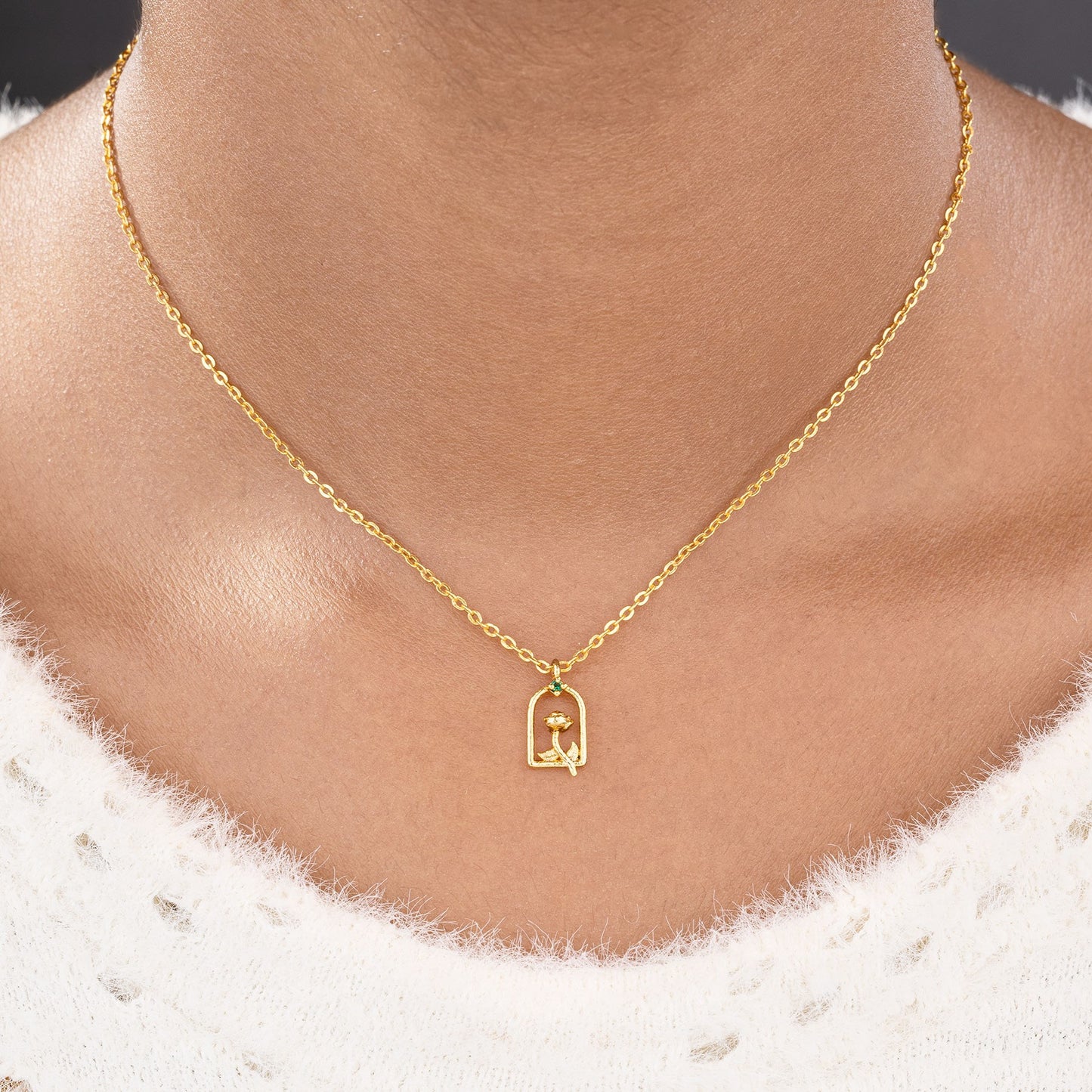 golden necklace with a small letter on it