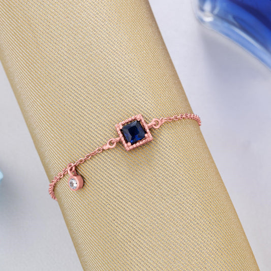 Rose Gold Bracelet with a Blue Stone and hanging stud