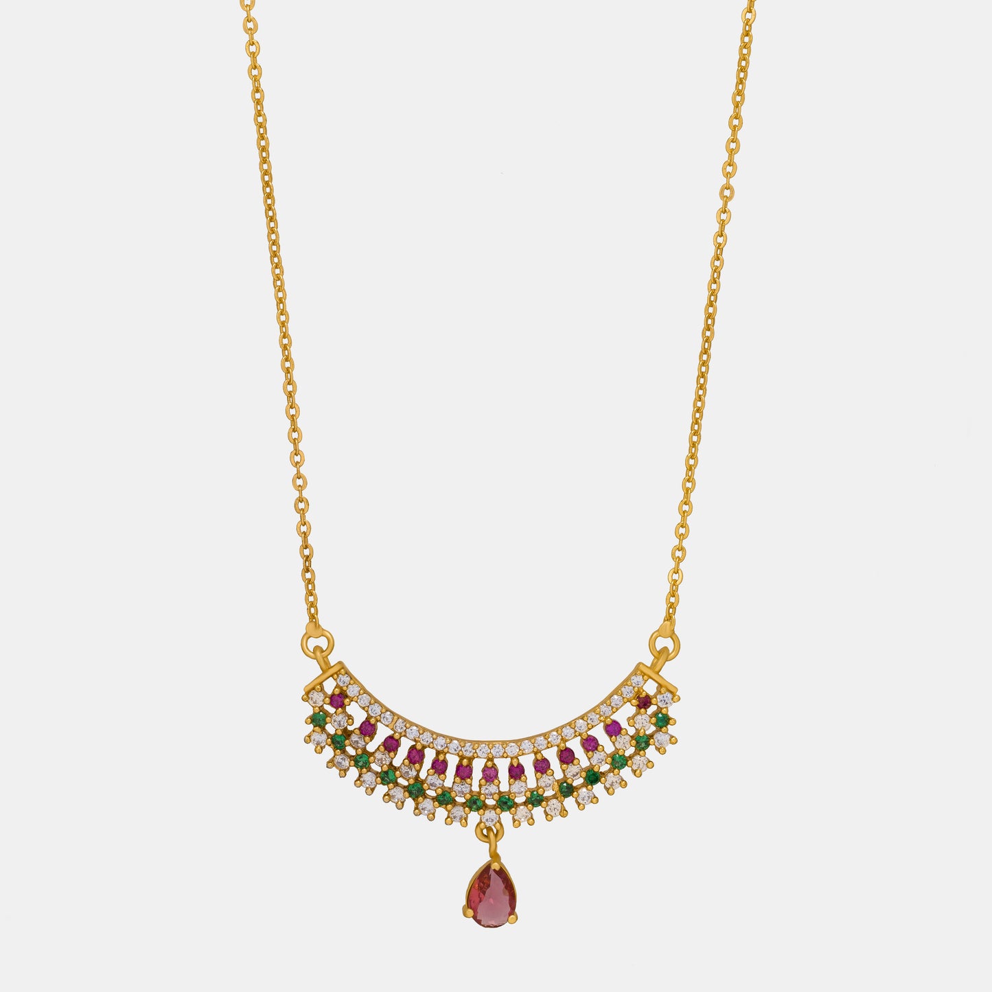 golden necklace with a ruby and emerald stone