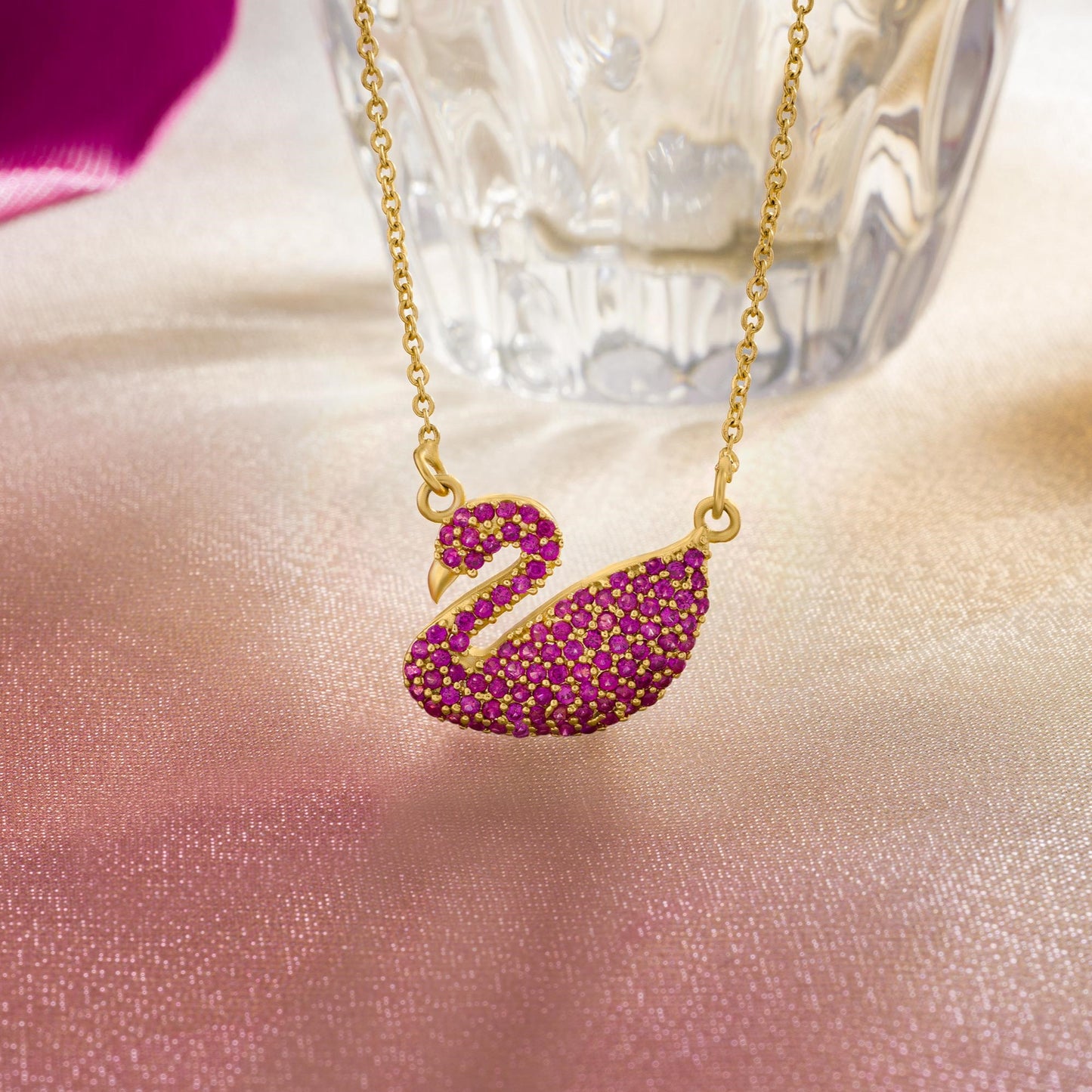 golden necklace with a stone swan