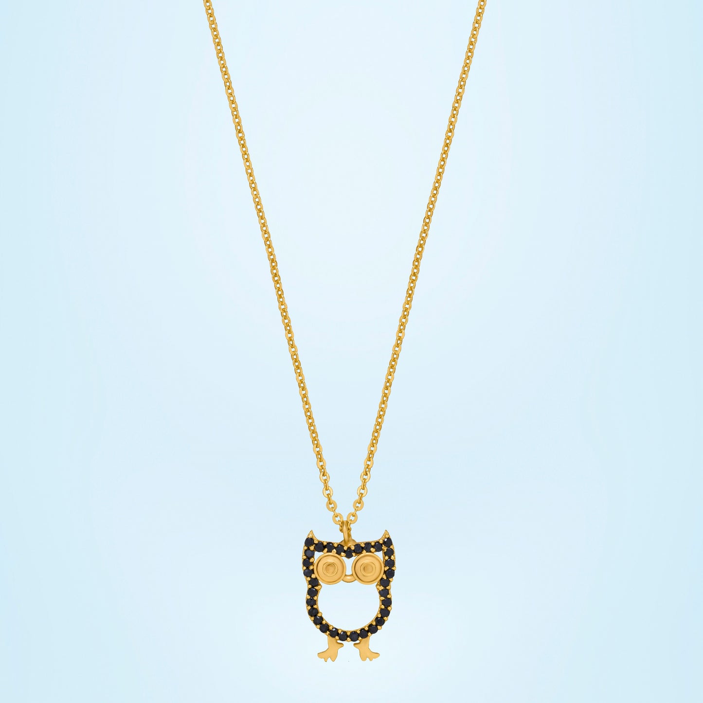 golden necklace with a black and white owl