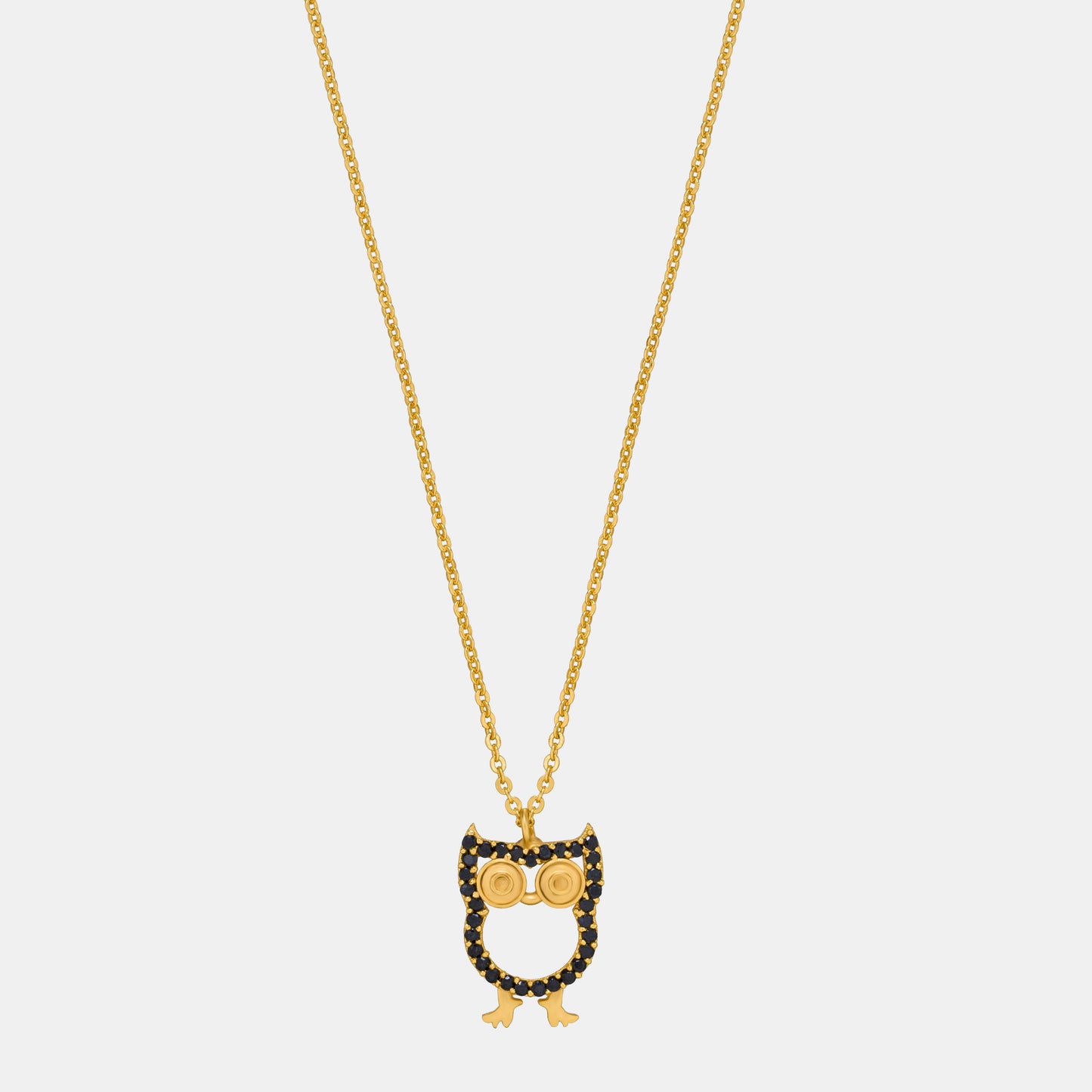 golden necklace with a black and white owl