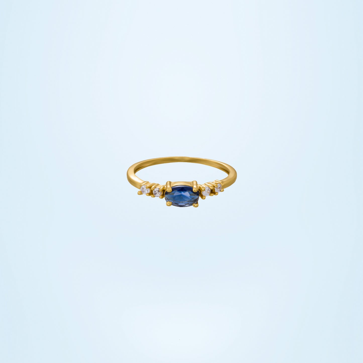 golden ring with a sapphire and diamonds