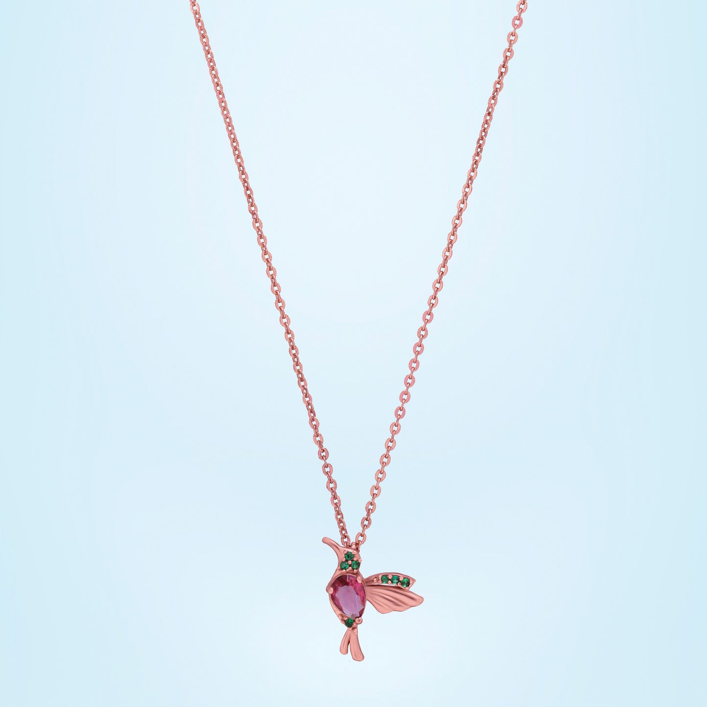 rose gold necklace with a pink bird pendant