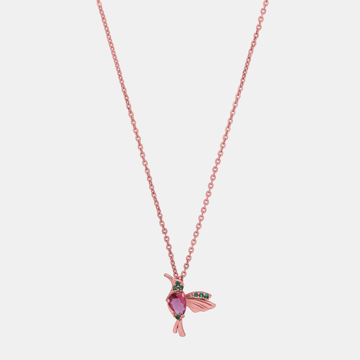 rose gold necklace with a pink bird pendant