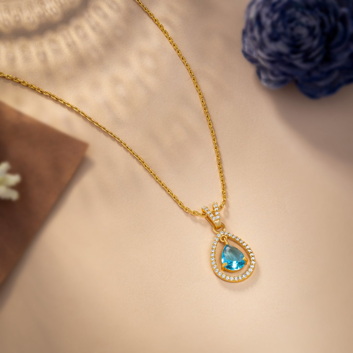 golden necklace with a stone and diamonds