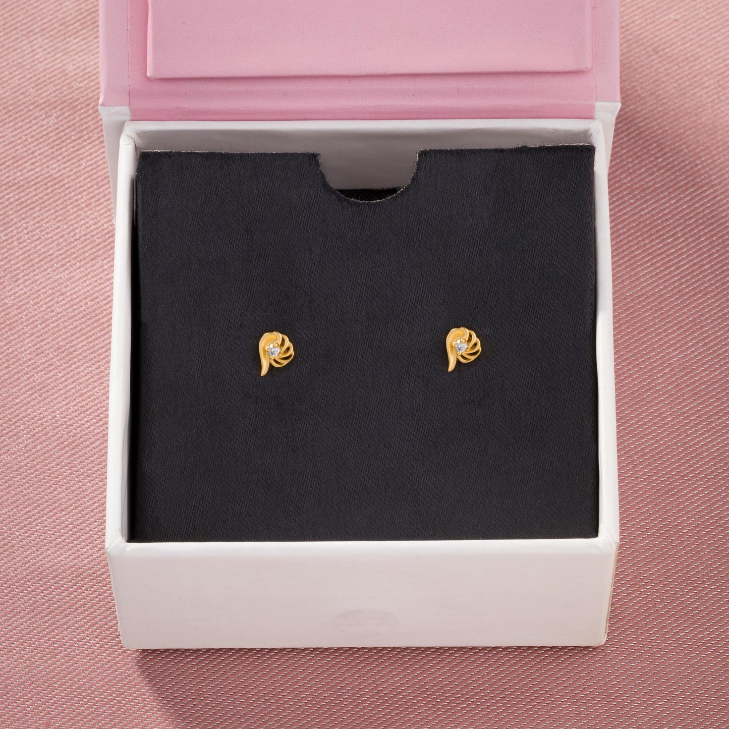 pair of golden earrings with a stone