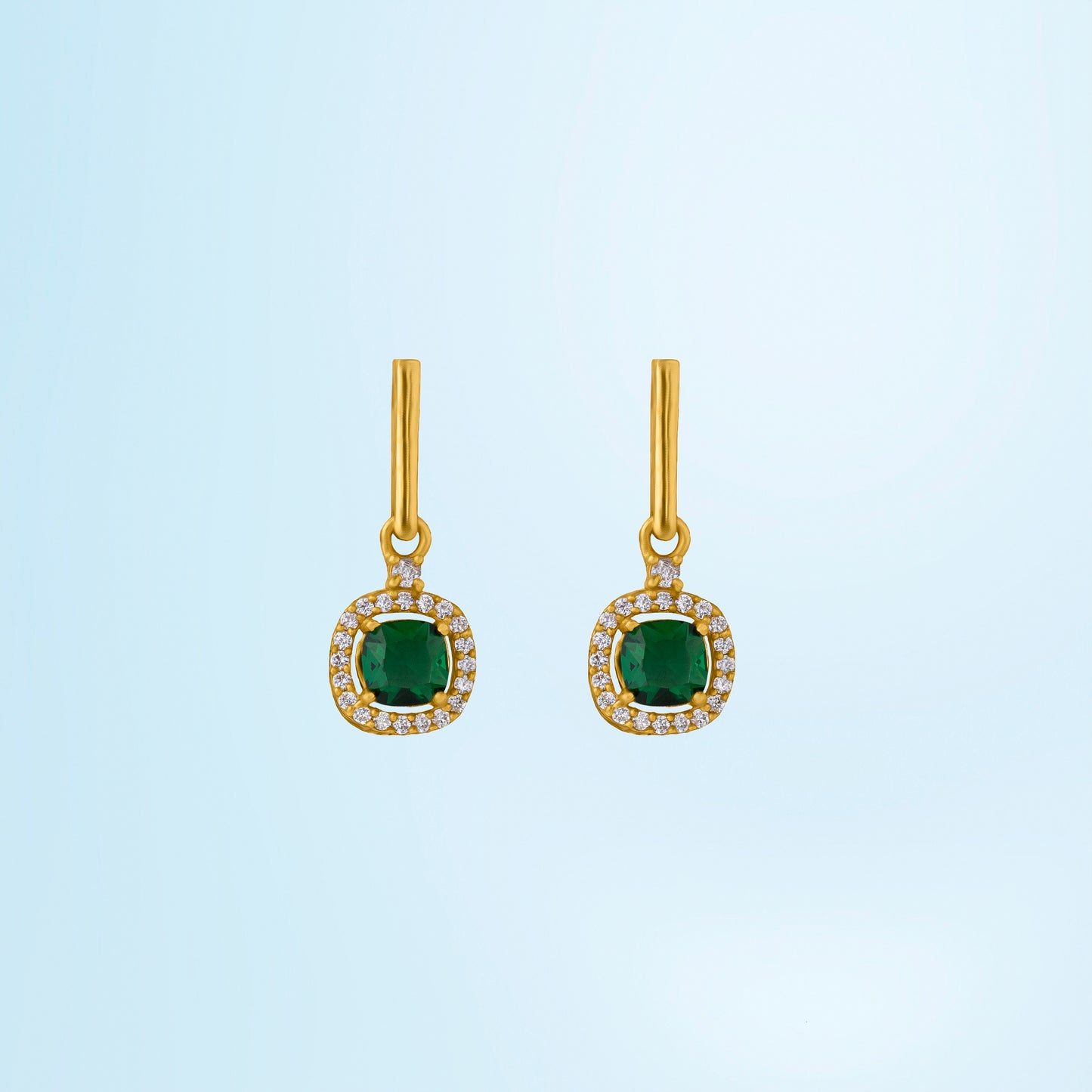 pair of earrings with a ruby stone and diamonds