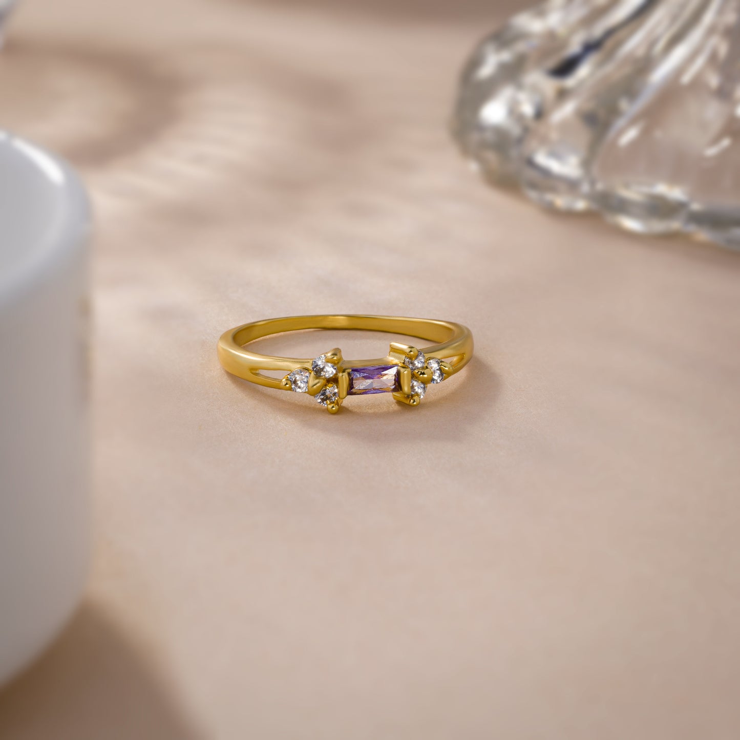 golden ring with a stone and two white diamonds