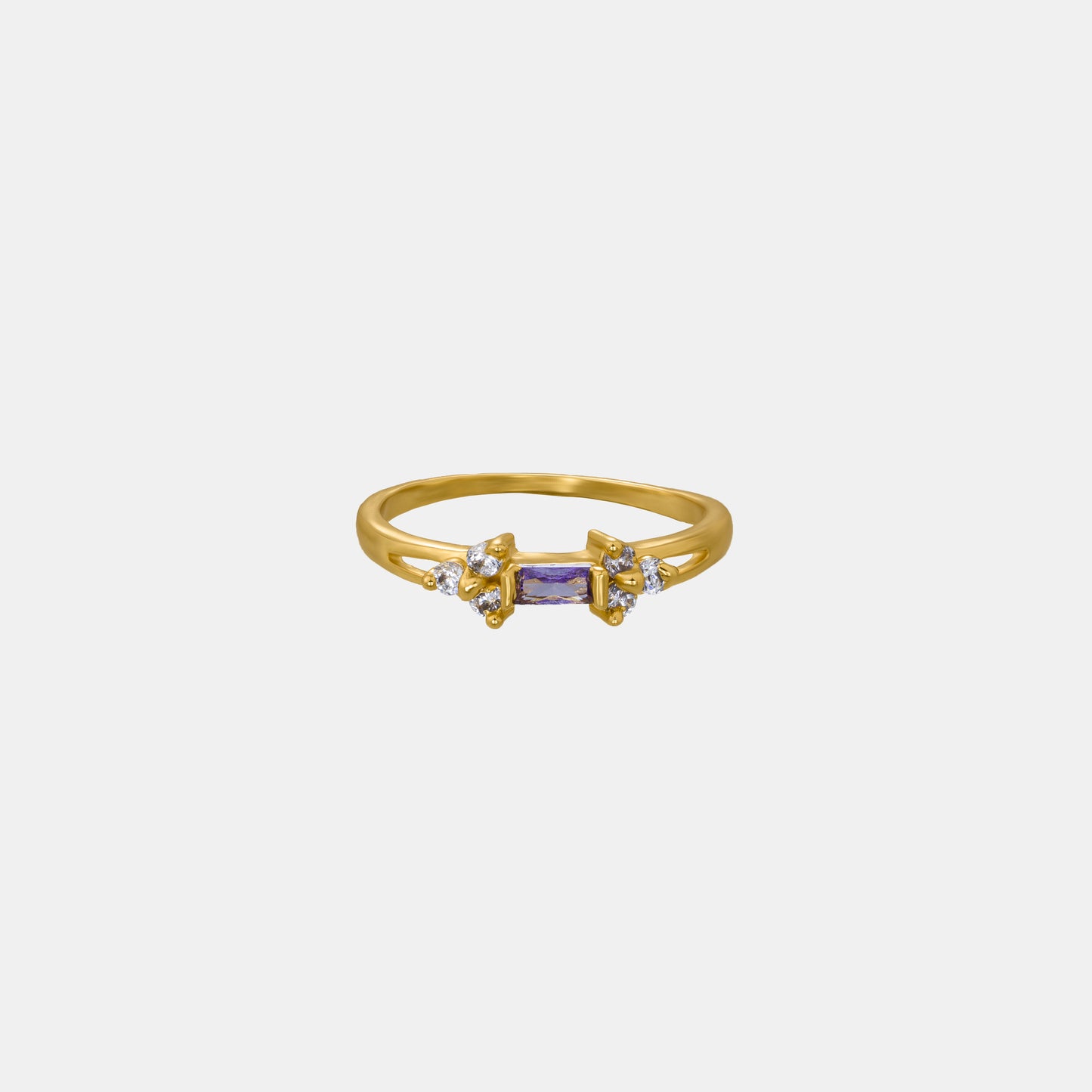 golden ring with a stone and two white diamonds