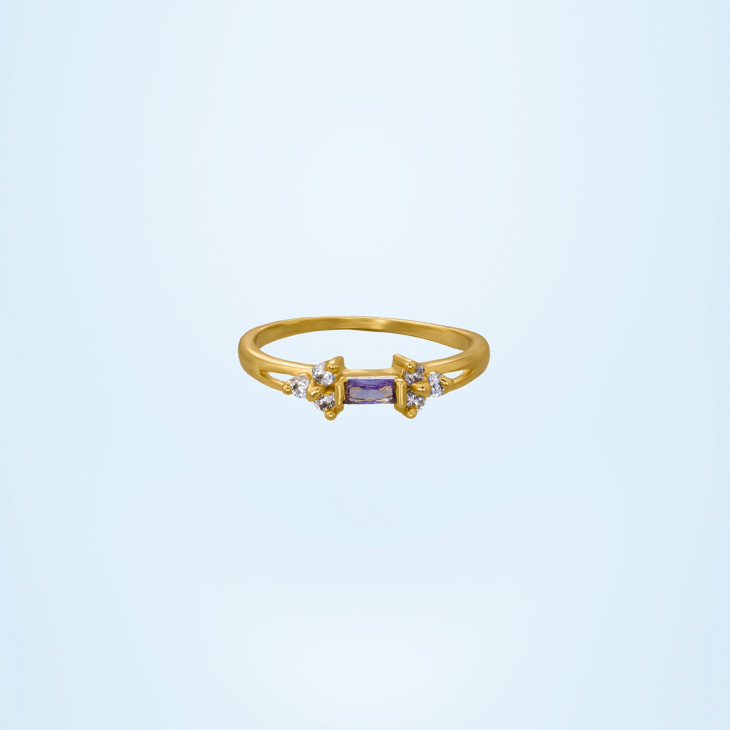 golden ring with a stone and two white diamonds