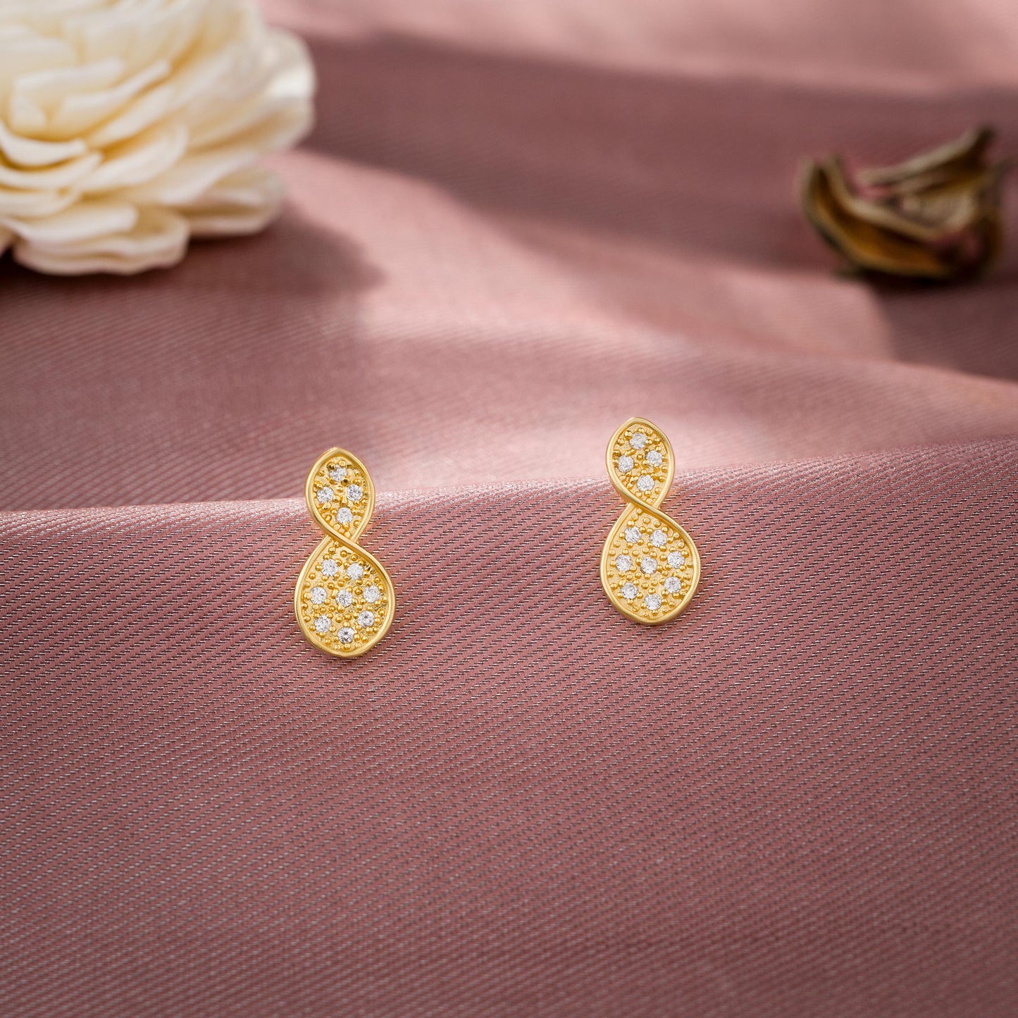 pair of golden earrings with diamonds