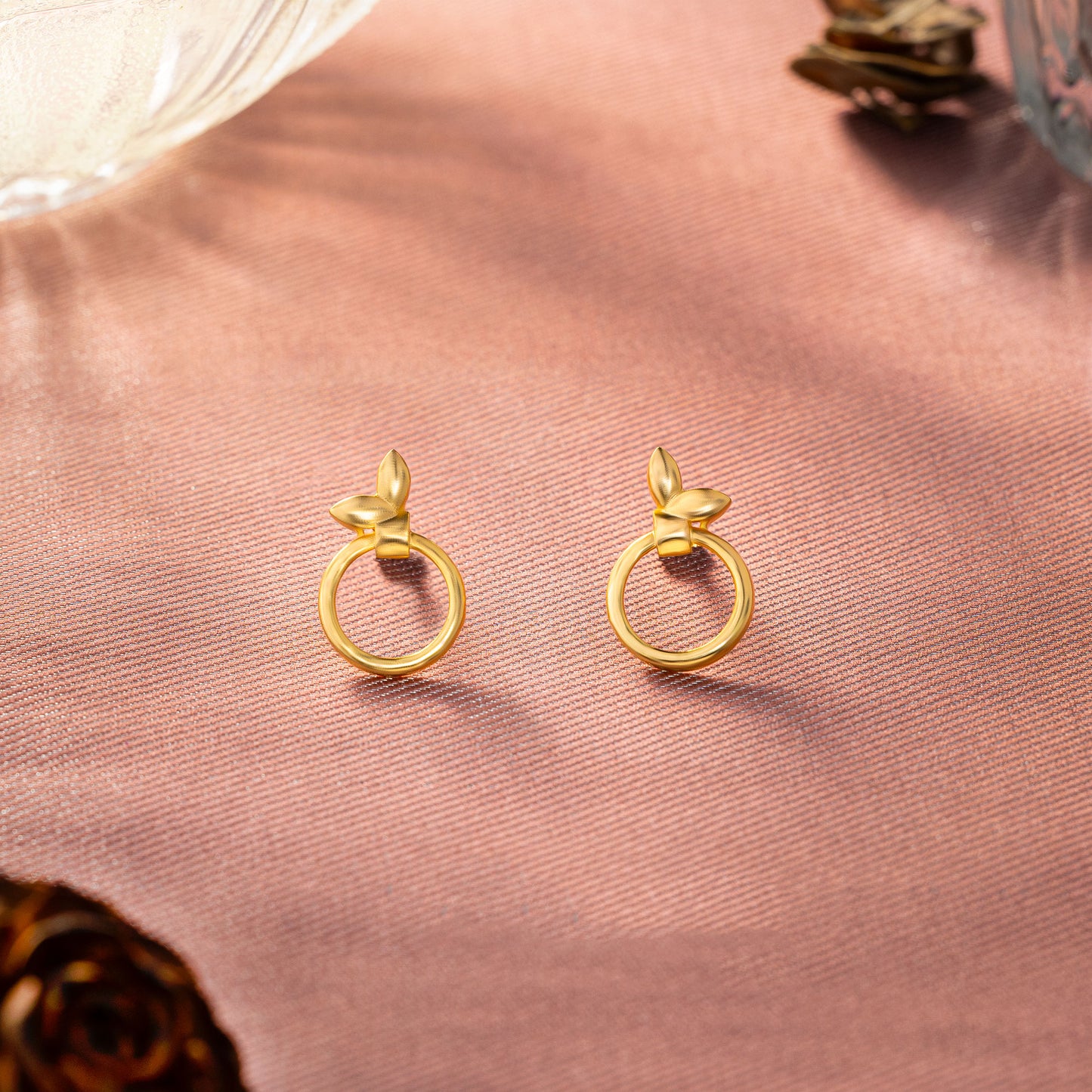 pair of golden earrings with a flower