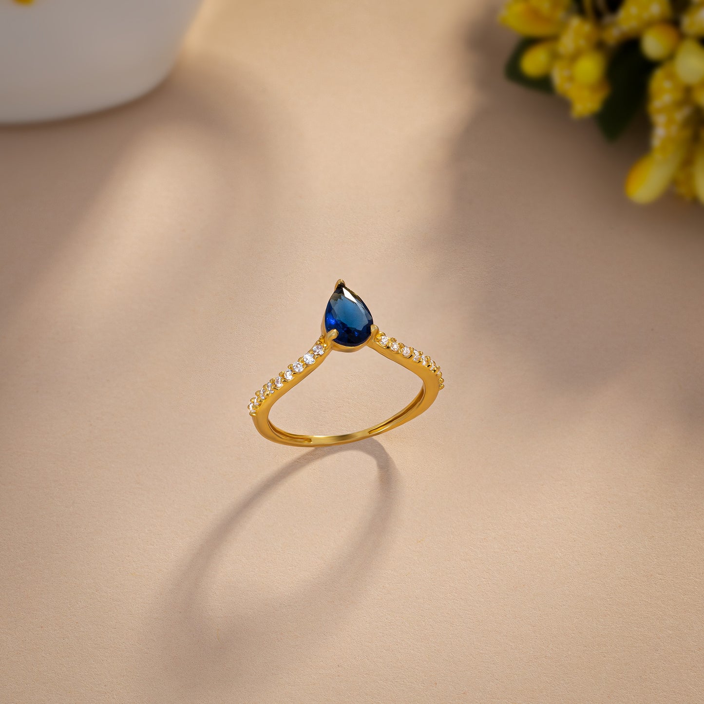 golden ring with a blue sapphire and diamonds