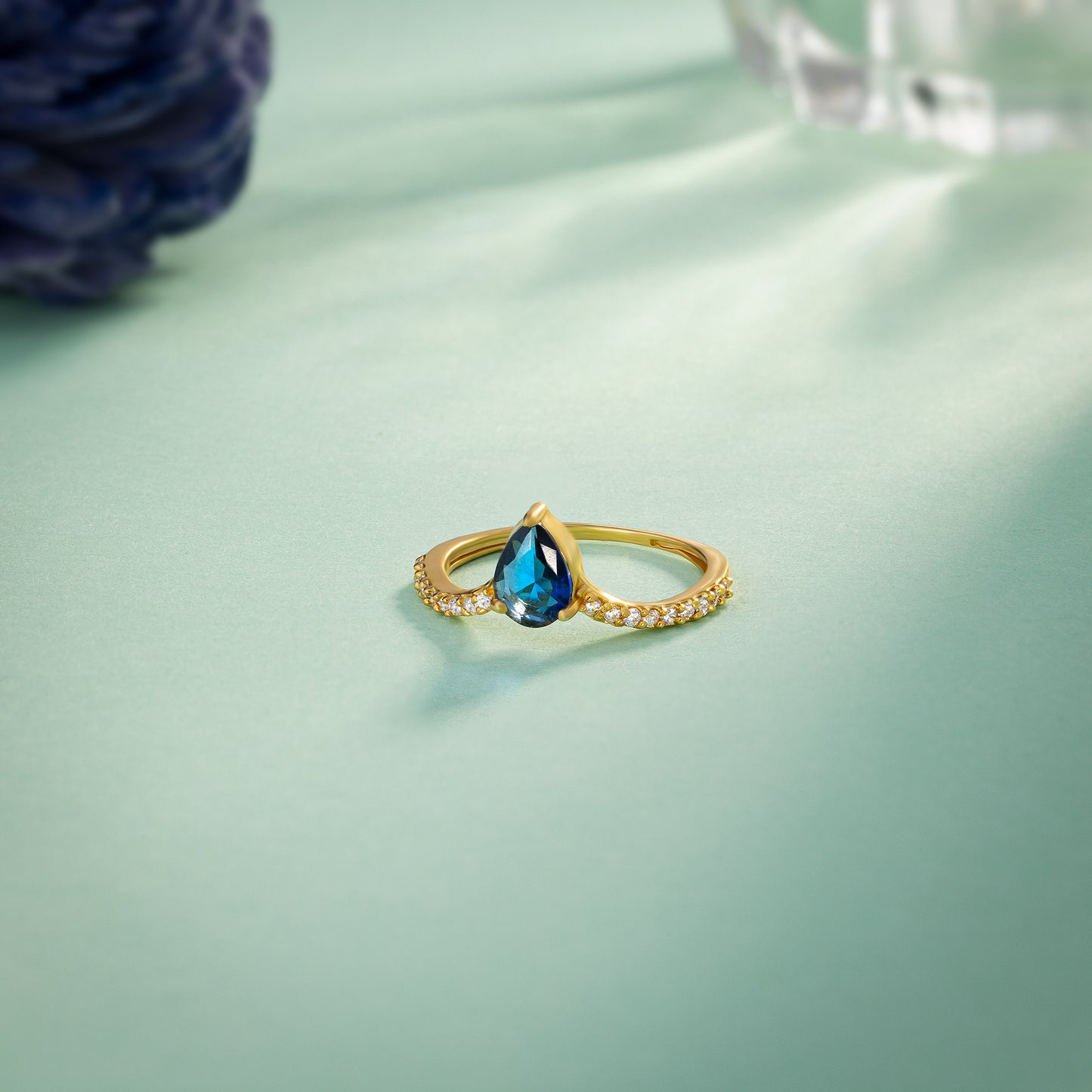 golden ring with a blue sapphire and diamonds