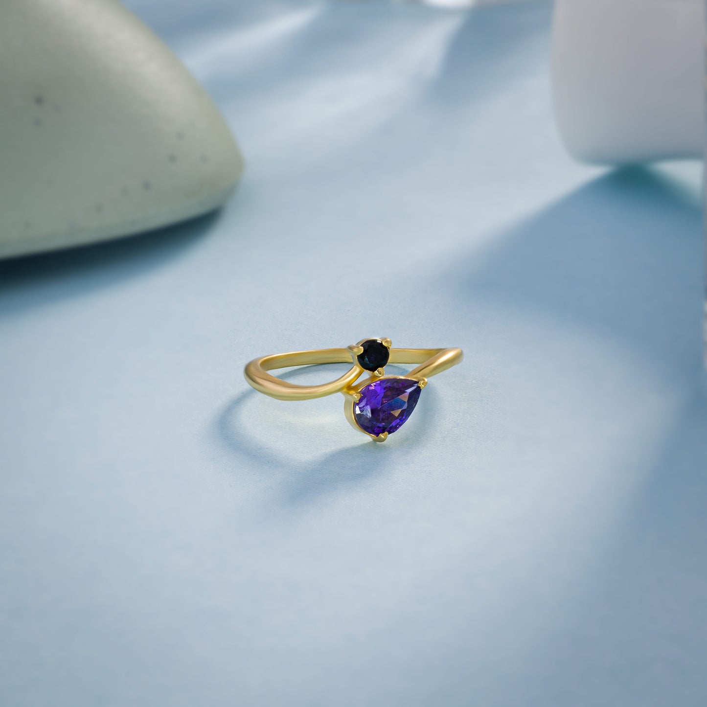 golden ring with a trillion cut sapphire stone