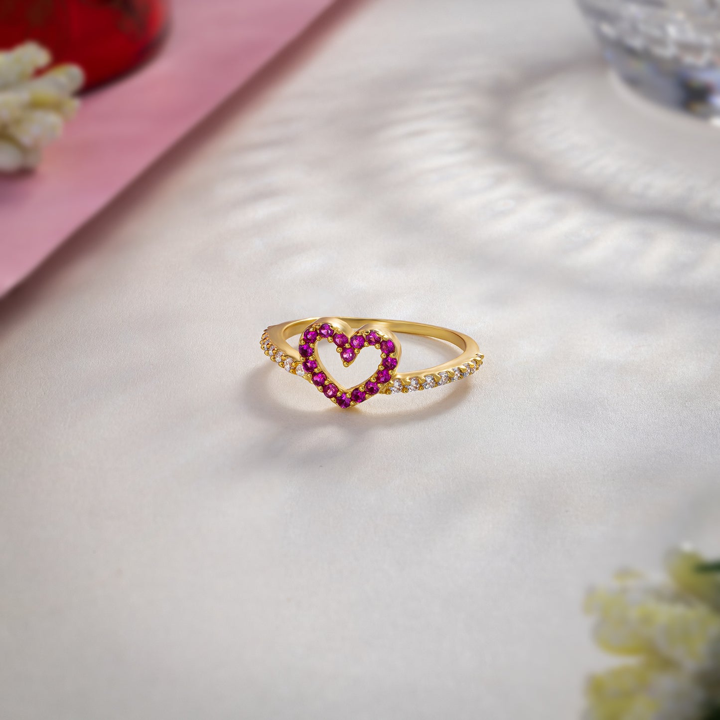 golden ring with a heart shaped ruby stone