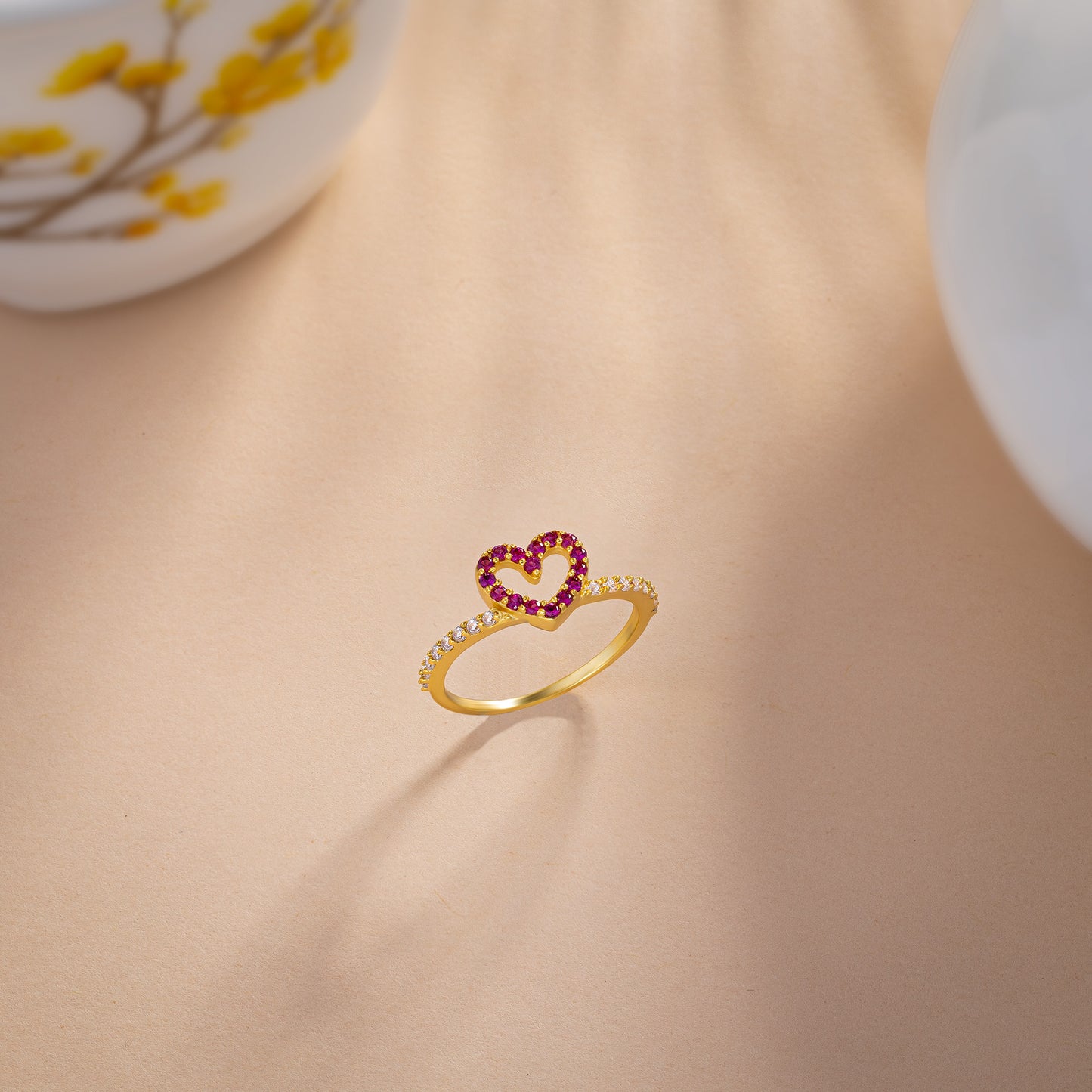 golden ring with a heart shaped ruby stone