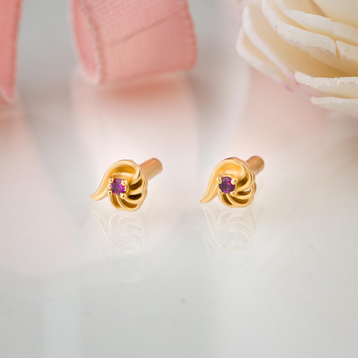 pair of golden earrings with a stone