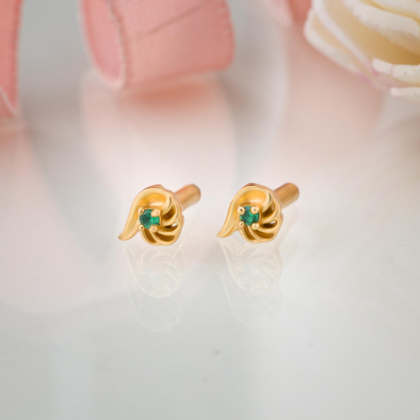 pair of golden earrings with a stone