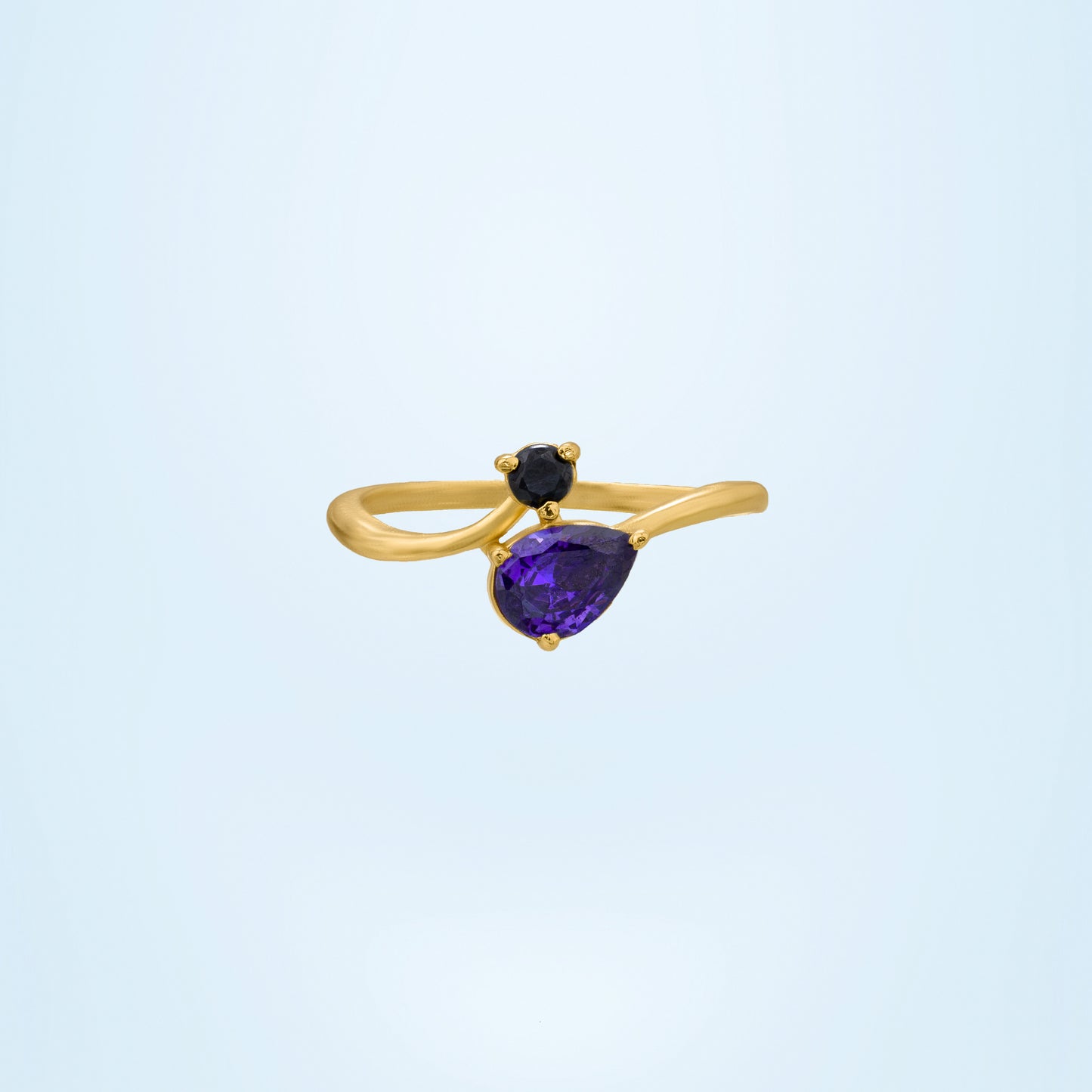 golden ring with a trillion cut sapphire stone