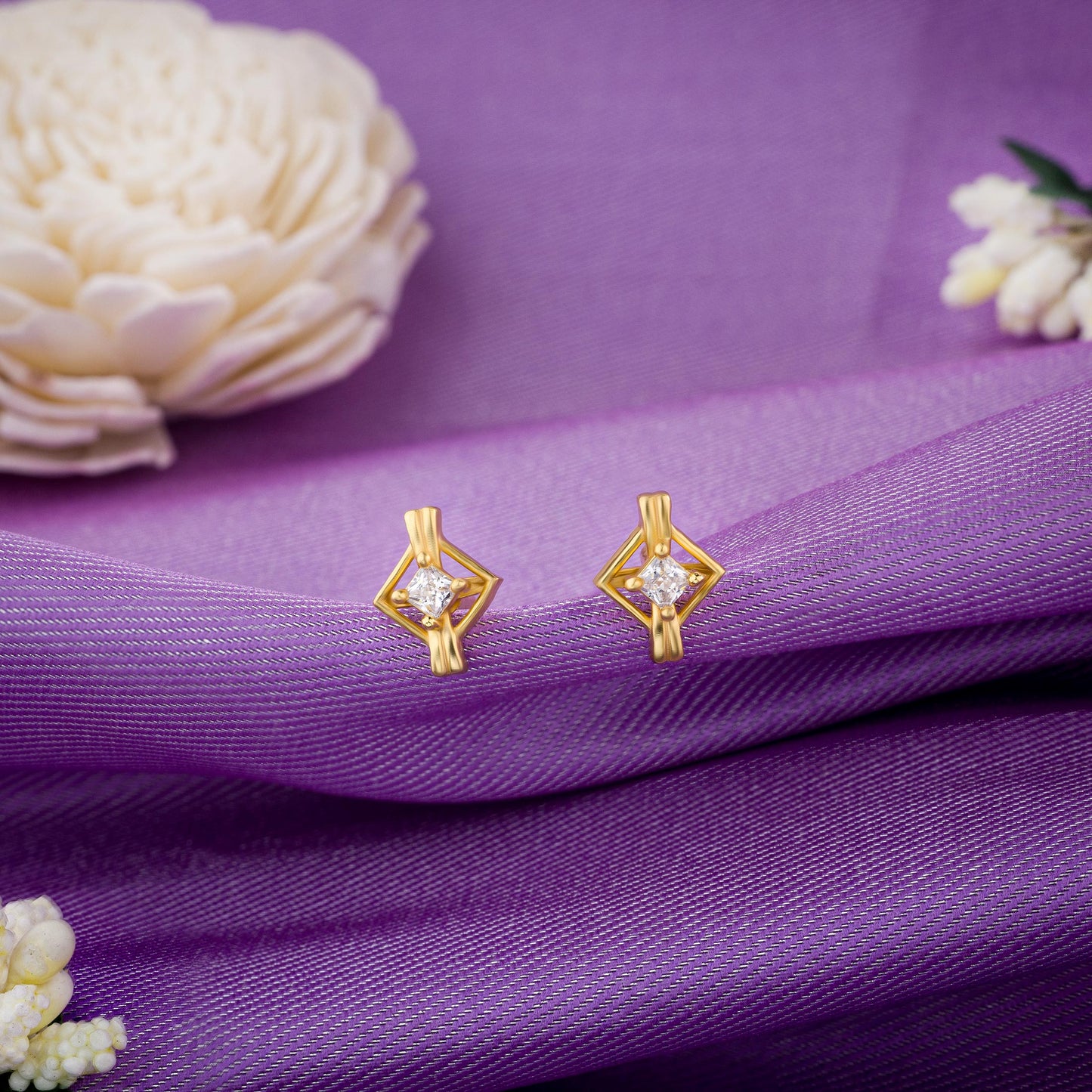 pair of golden earrings with a diamond