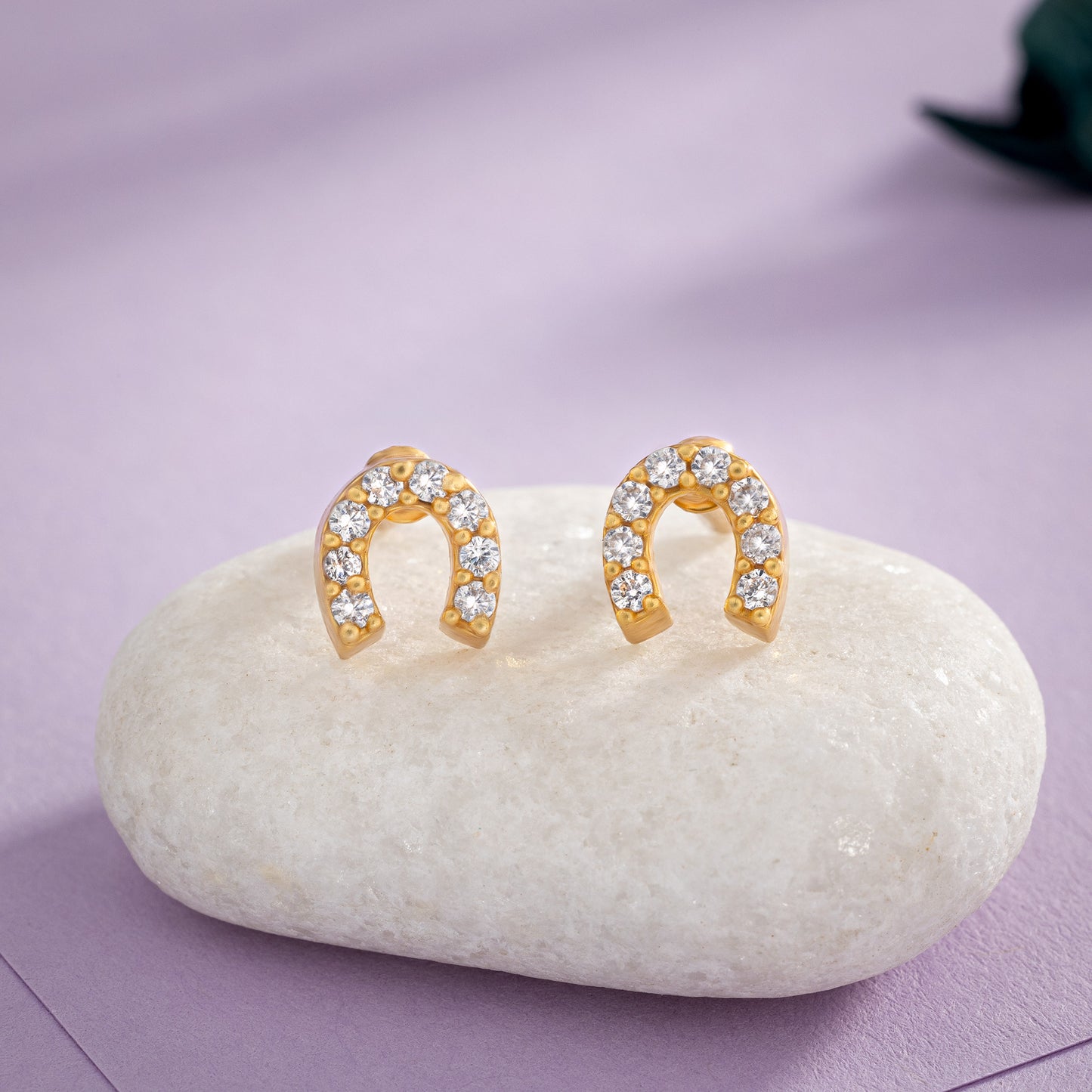 pair of golden earrings with white diamonds