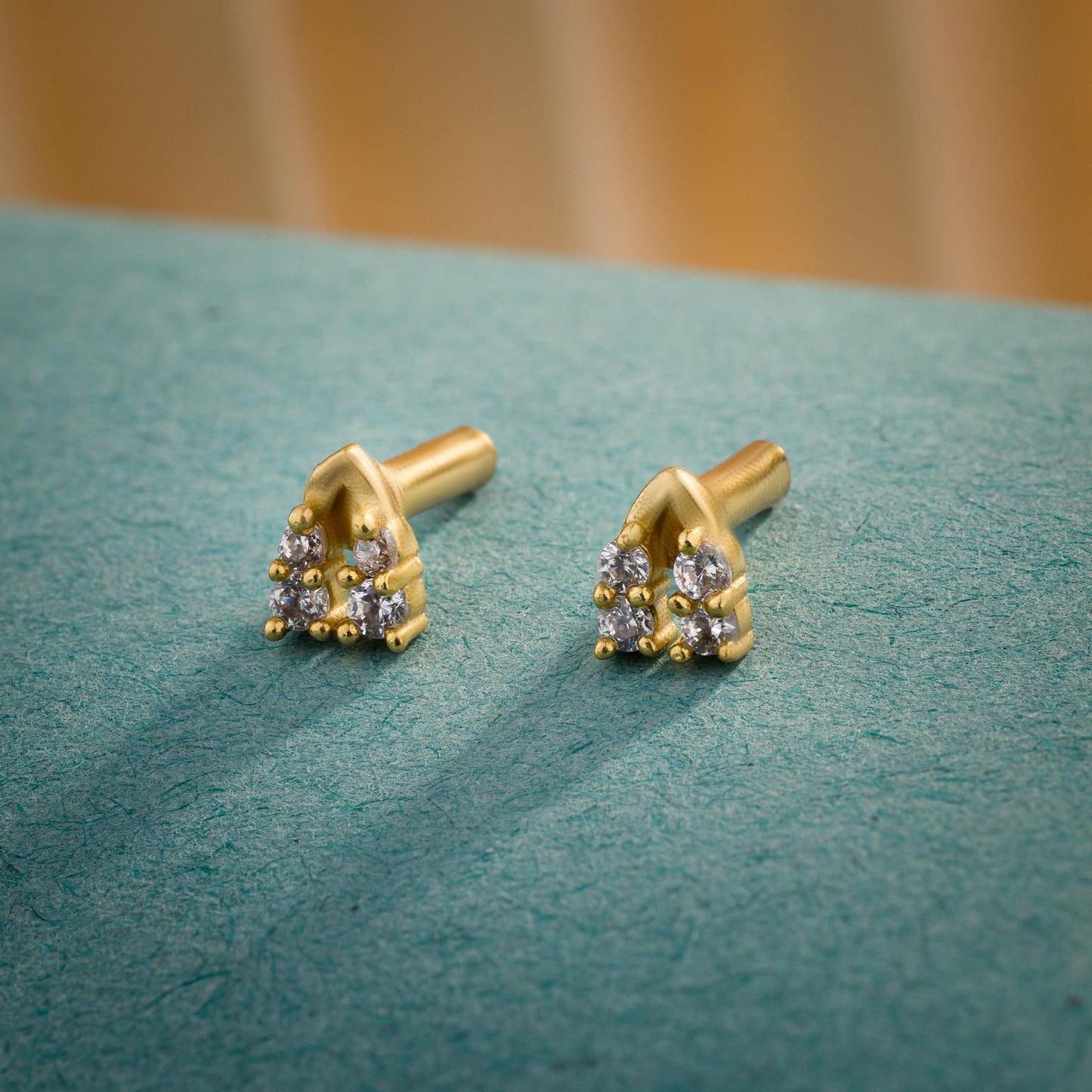 pair of golden earrings with diamonds