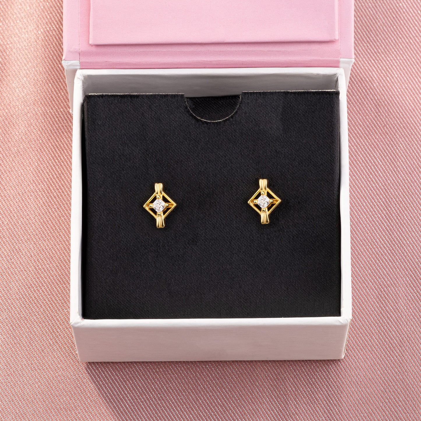 pair of golden earrings with a diamond