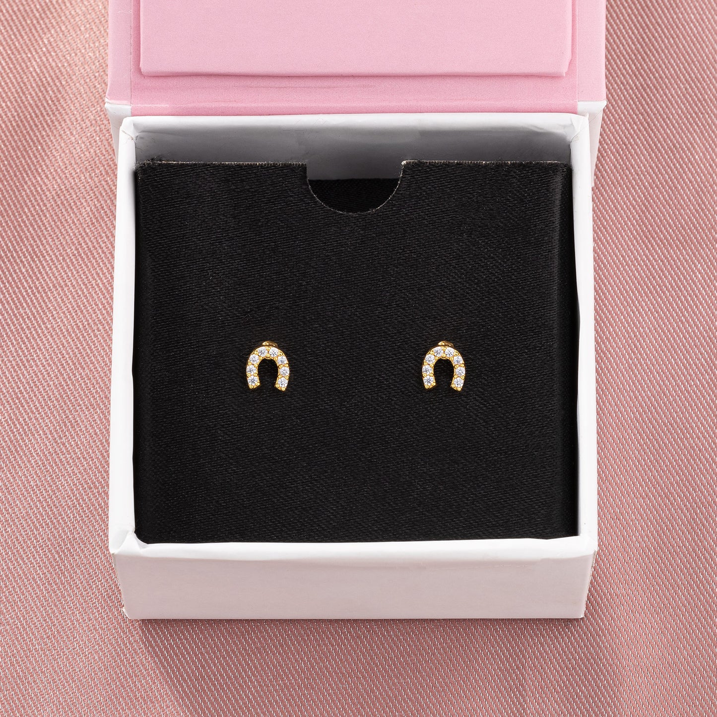 pair of golden earrings with white diamonds