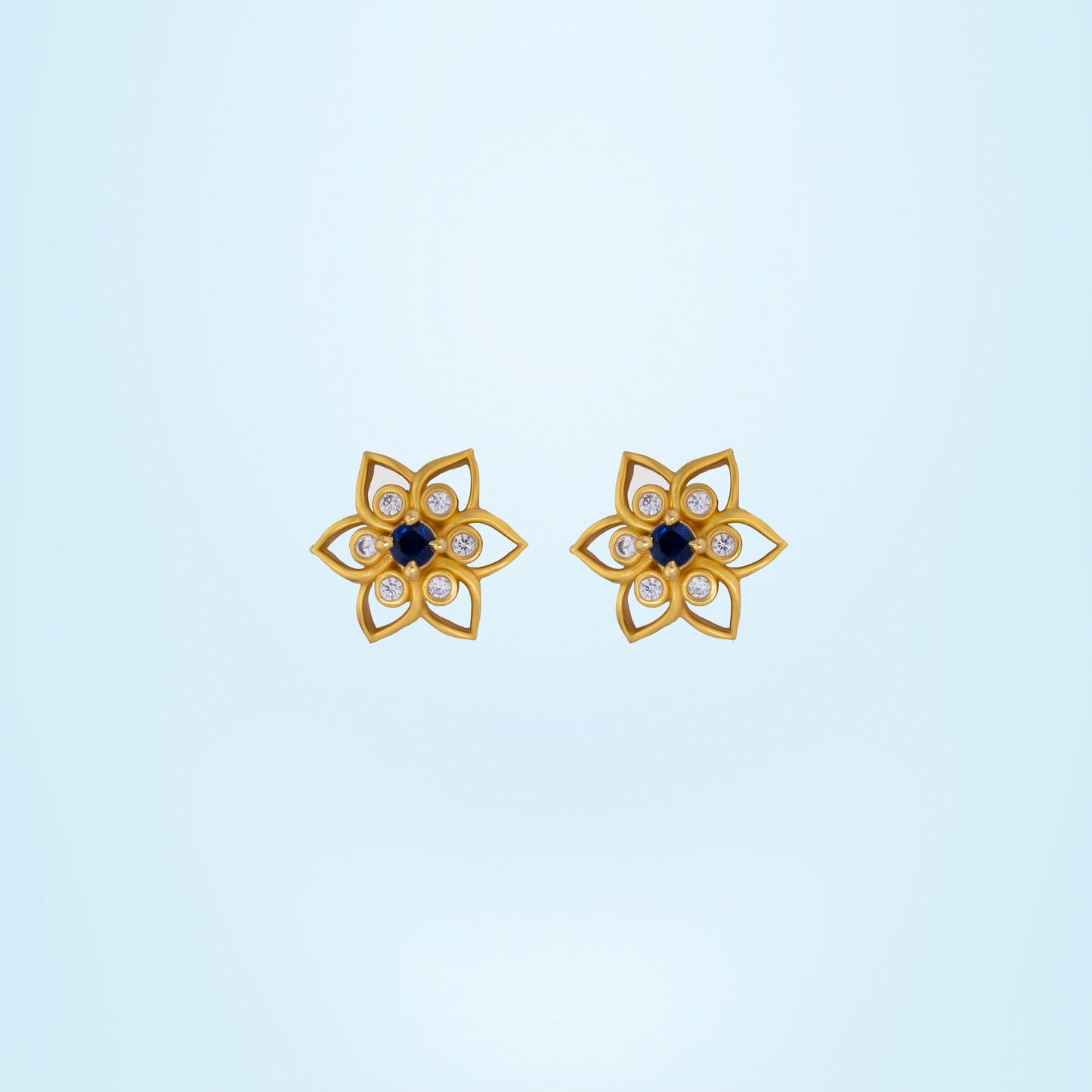 golden earring with a sapphire stone