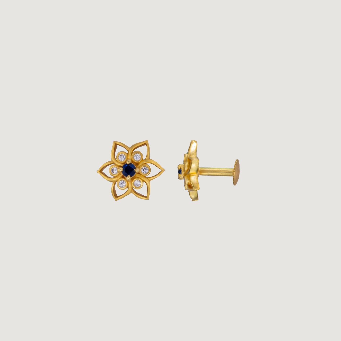 golden earring with a sapphire stone