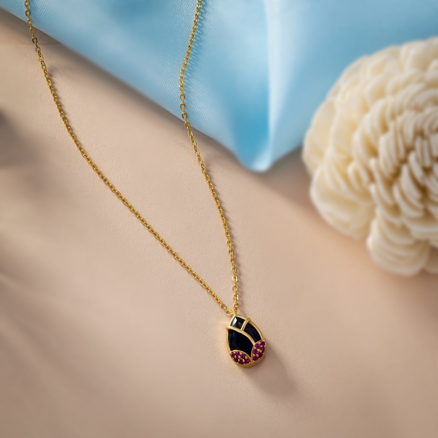 golden necklace with a large tear shaped pendant