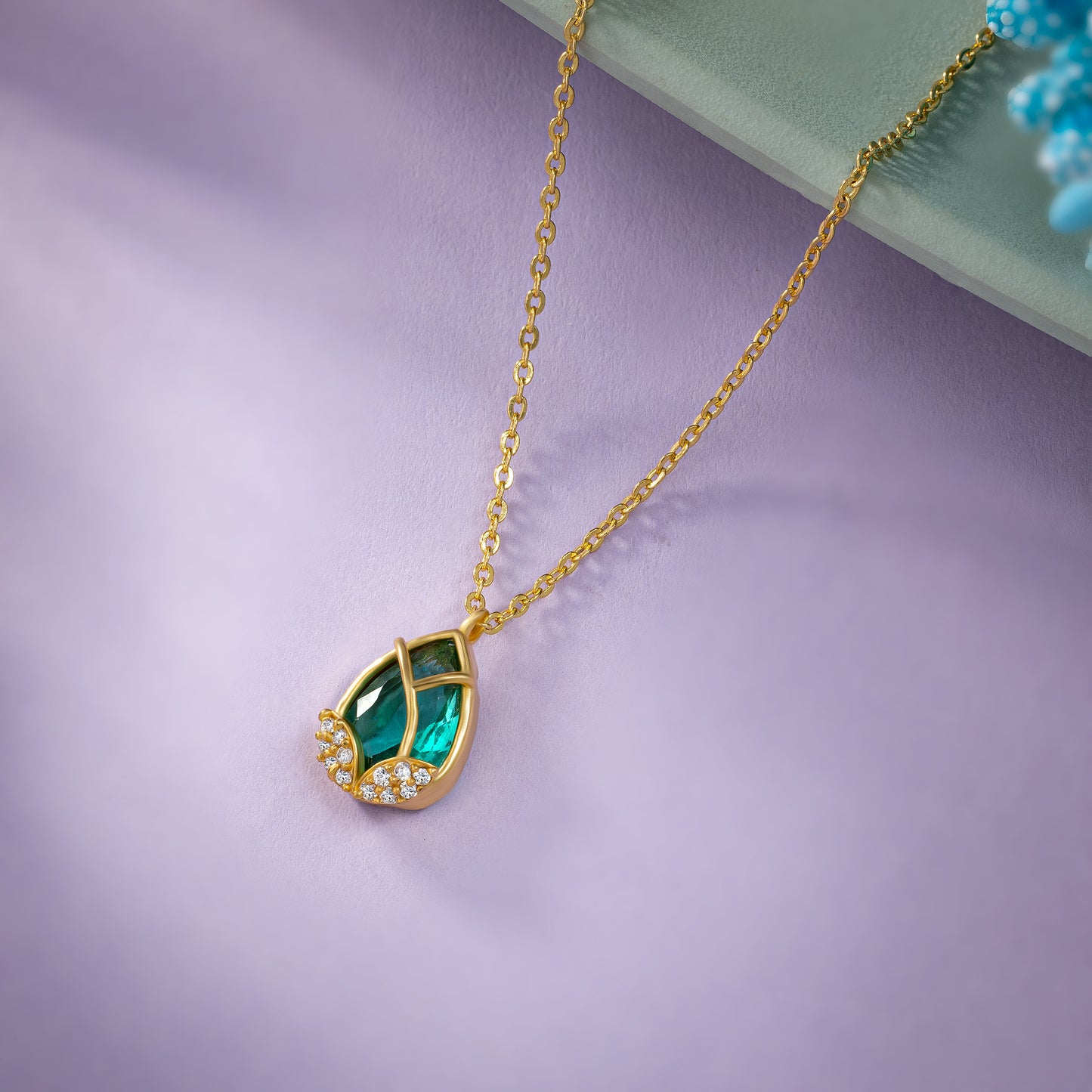 golden necklace with a large tear shaped pendant