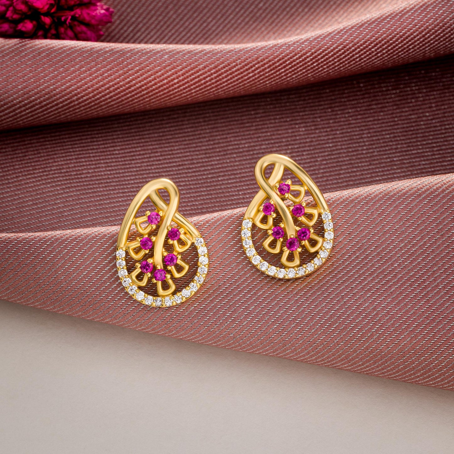 pair of golden earrings with ruby and diamonds