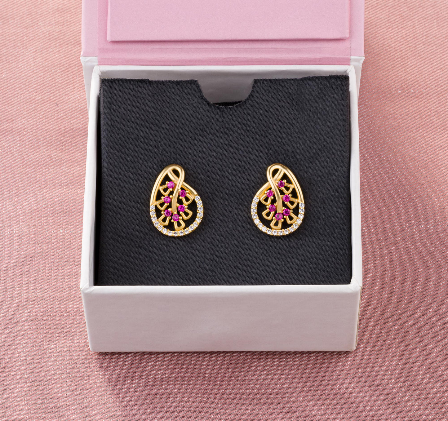 pair of golden earrings with ruby and diamonds