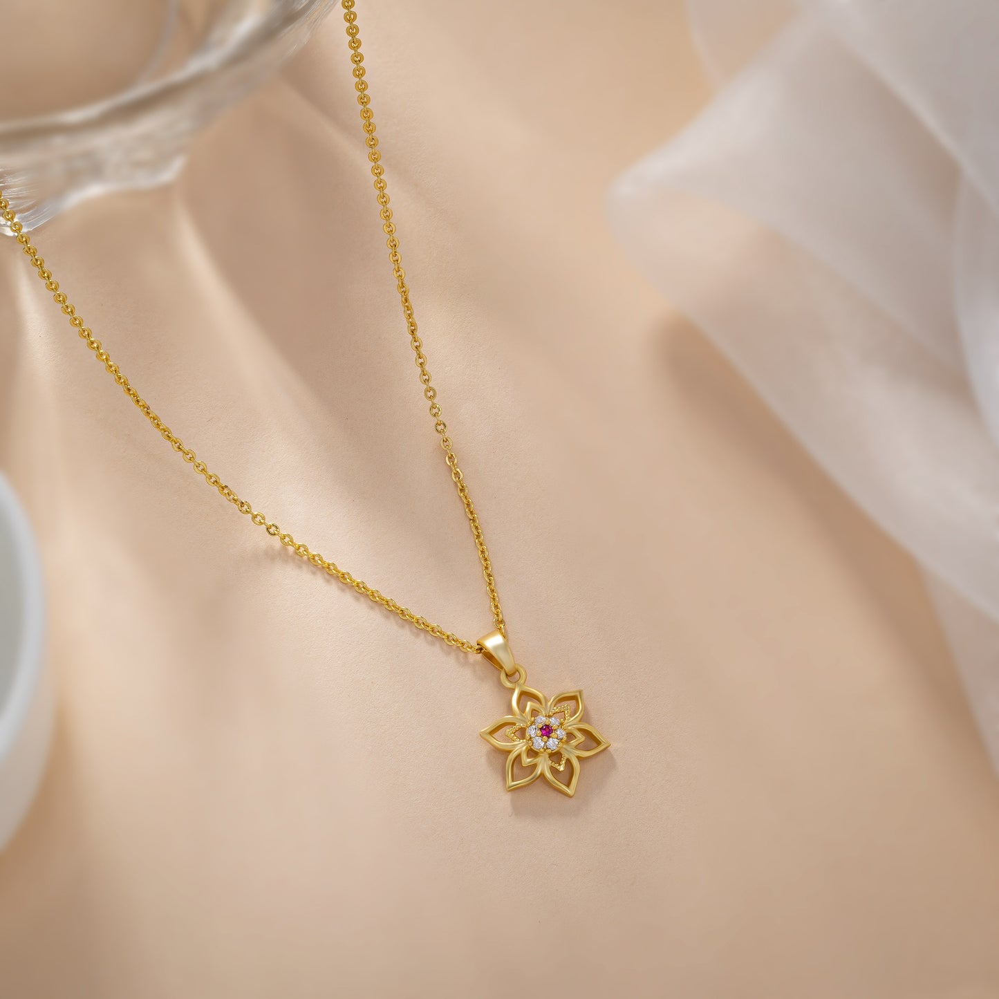 golden necklace with a flower design on it