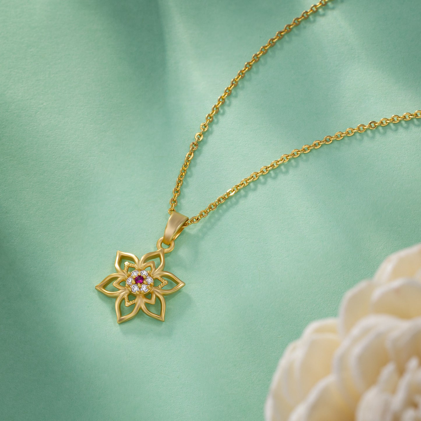 golden necklace with a flower design on it